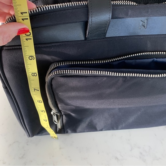 Black Travel Bag with Structured Design and Metal Feet - Picture 14 of 16